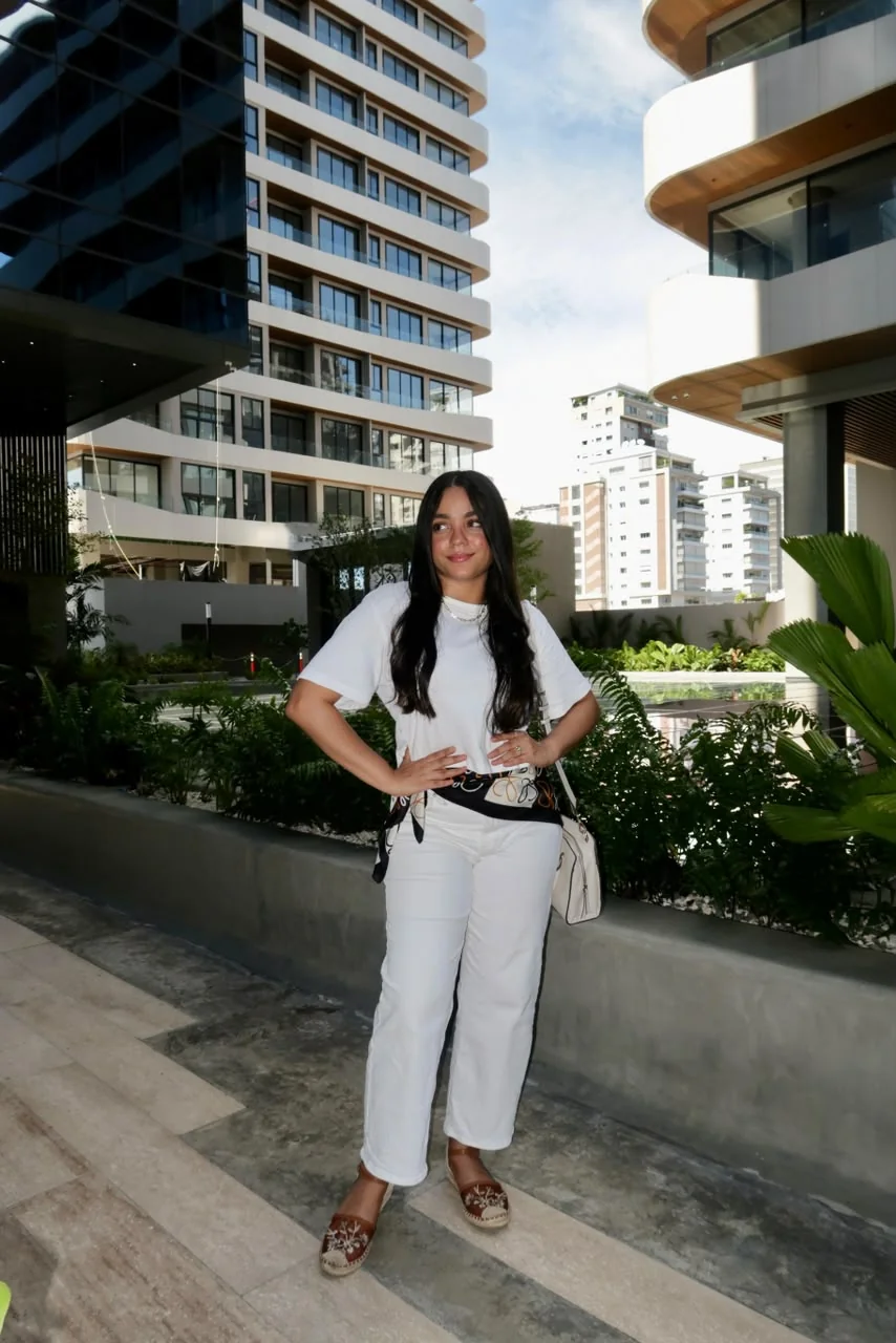 Wileini de pie con conjunto blanco en un espacio urbano